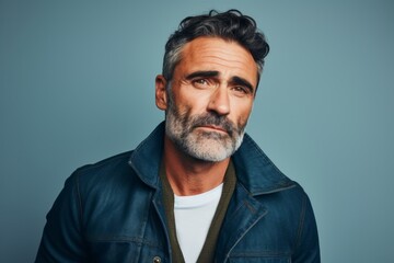 Portrait of a serious mature man in a denim jacket. Men's beauty, fashion.