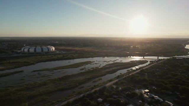 Aerial view of Estadio Unico Madre de Ciudades Stadium and the surrounding wetlands at sunset, Santiago del Estero, Argentina.