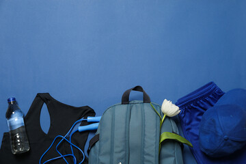 Sportswear and accessories, with flowers, on a blue background.