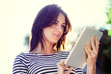 Woman, nature and sunshine with tablet for online communication, reading ebook or social media in...