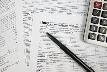 Tax time concept. Tax form with office supplies on white. financial document.