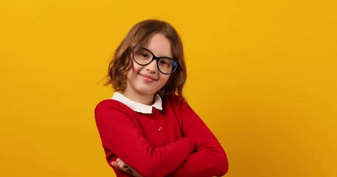 Teenage Schoolgirl Trying On Glasses to Improve Vision Against Yellow Background