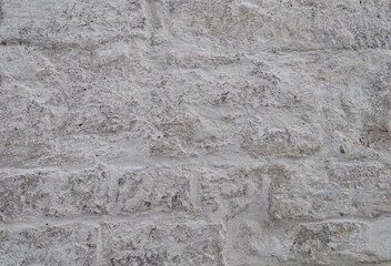 Texture of old rough white stone wall
