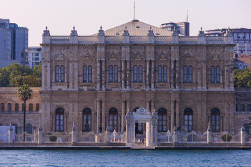 Fototapeta premium View from the water of the Bosphorus Strait to ancient palaces and buildings. Public place on the street of Istanbul, Türkiye.