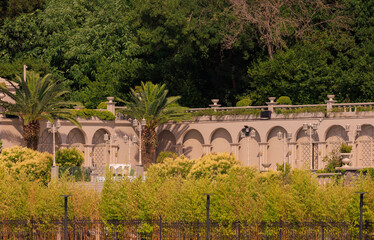 Obraz premium View from the water of the Bosphorus Strait to ancient palaces and buildings. Public place on the street of Istanbul, Türkiye.