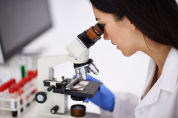 Woman, microscope and laboratory experiment with particles for dna investigation, examination or...