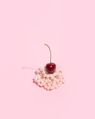 A creative fruit composition, a ripe cherry on a beaded cake, a summer dessert.