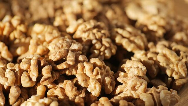 Walnut kernels rotating. walnut close up lies under beams of the sun. Walnut close up. product rich in minerals and vitamins. Macro 4K
