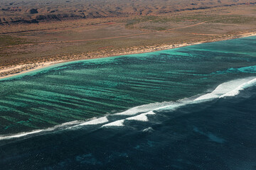 Scenic flight over the Ningaloo reef in Exmouth, Australia. Aerial view of Cape range national park, the lagoon, the reef break and the ocean. Breathtaking point of view, amazing holiday experience. © Elsa
