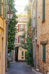 Picturesque cobbled street in the old town of Antibes on the French Riviera in the South of France - 758786123