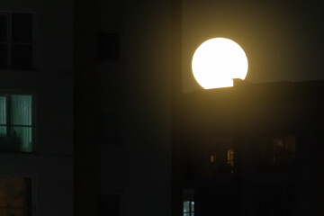 Fototapeta premium Night view of the city. Black sky and moon, light and cityscape.