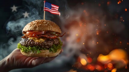 Hand Holding Burger with American Flag Toothpick - obrazy, fototapety, plakaty