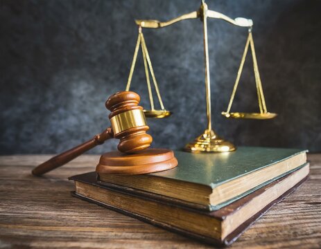 Wooden gavel, Vintage law scales and books on the desk front concrete wall background. Symbols of justice. Retro old style filtered photo