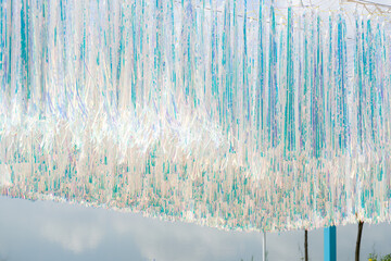 A sunshade pavilion decorated with colorful plastic strips in the park