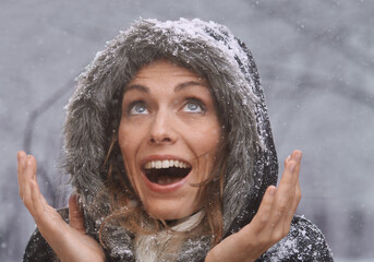 Nature, excited and face of woman with snow outdoors for season, snowing weather and cold climate....