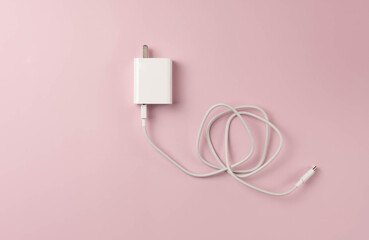 Mobile phone charger on pink background