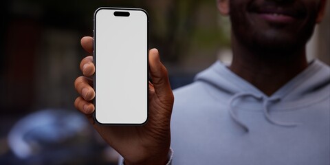 Black African-American hand displays a modern smartphone with a blank screen  - 758814377