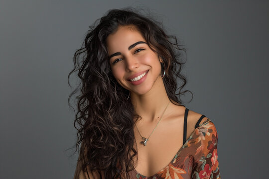 Smiling happy attractive hispanic young woman posing in studio shot
