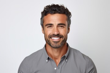 Portrait of handsome young man with beard and mustache smiling at camera - obrazy, fototapety, plakaty