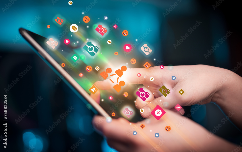 Poster close-up of a hand using tablet with social media icons