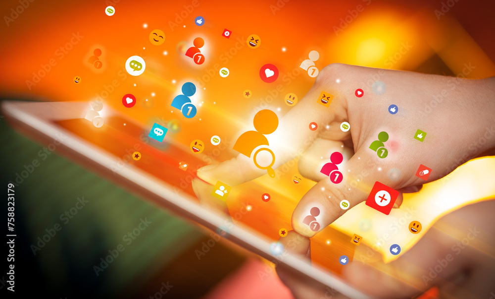 Poster close-up of a hand using tablet with social media icons