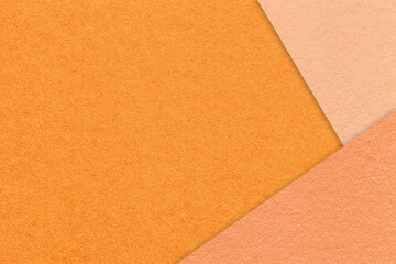 Texture of craft orange color paper background with coral and peach fuzz border. Vintage abstract cardboard.