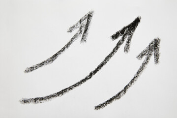 Many graceful smooth Hand drawn black chalk arrows. The concept of business, choosing direction, moving forward. Abstract sign, background, texture. Blurred