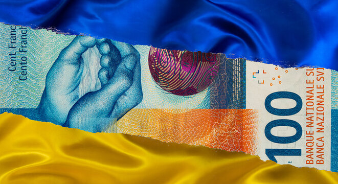 100 Swiss franc banknote and Ukrainian national flag