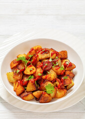 fried spanish potatoes with paprika sauce in bowl