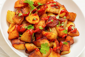fried spanish potatoes with paprika sauce in bowl