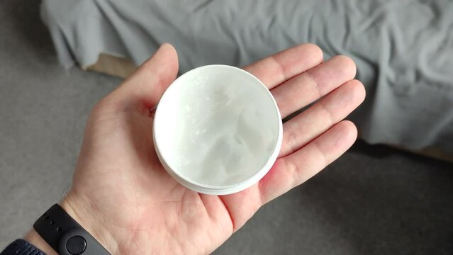 Man holding the cotton pad in his hand