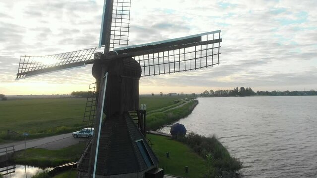 Aerial view of small windmill (Doris Mooltsje) near lake during dawn, Oudega, Netherlands