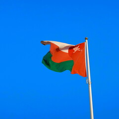 Proud National Flag Against Blue Sky, Emblem of Sovereignty Flutters High