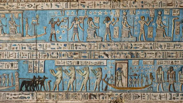 Ancient Egyptian hieroglyphs and bas-reliefs close-up in Dendera temple or Temple of Hathor. Egypt. Dendera Temple complex, one of the best-preserved temple sites from ancient Upper Egypt.