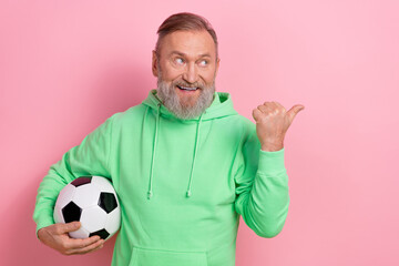 Photo of dreamy funky guy dressed green hoodie catching football ball looking showing thumb empty...