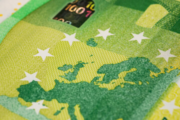 Concept Idea: A fragment of 100 euro banknote in macro as a background for finance theme