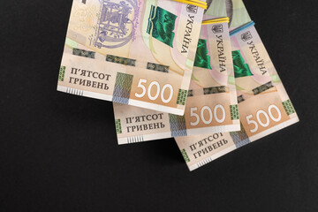 bundles of hryvnia on a black background. Ukrainian money. 500 hryvnia banknotes. A lot of Ukrainian money.