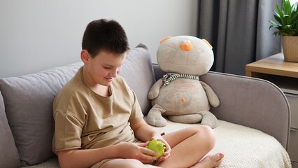 Smiling child solving puzzle with toy. Joyful engagement evident. Toy sparks excitement as puzzle...