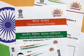 Indian Aadhaar card from Unique Identification Authority of India on Indian flag close up