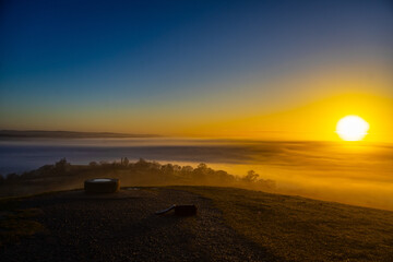 Capturing the Mystical Sunrise at the top Glastonbury Tor: A Stunning Blend of Mist, Sunlight, and Natural Beauty © You Got This Media