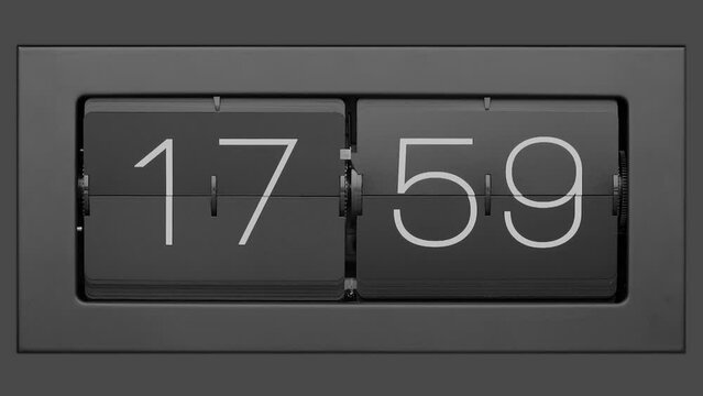 Flip clock quickly flips. Retro flip clock changing from 17:59 to 18:00. Slow motion. Close up. 