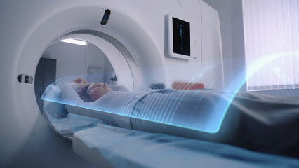Woman undergoes MRI or CT scan diagnostic, lies on bed moving inside the machine. VFX animation of...