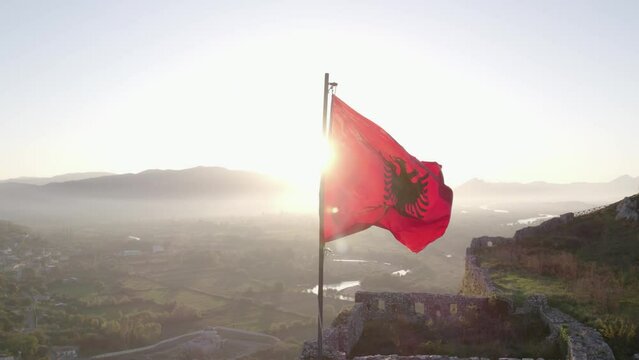 Aerial view of Albanian flag at Rozafa Castle during sunrise, Shkoder. Albania