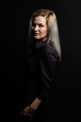 Blonde woman portrait, attractive adult girl in studio over black background.
