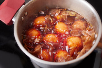A saucepan with boiled chicken eggs with onion husks. Coloring eggs in natural dyes for the Easter holiday. 