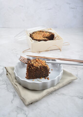 premium freshly baked dark cocoa chocolate brownie gold flower and earl grey peanut round birthday cake with walnut in wood bento box on white marble halal food sweet dessert menu for pastry cafe shop