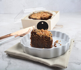 premium freshly baked dark cocoa chocolate brownie gold flower and earl grey peanut round birthday cake with walnut in wood bento box on white marble halal food sweet dessert menu for pastry cafe shop