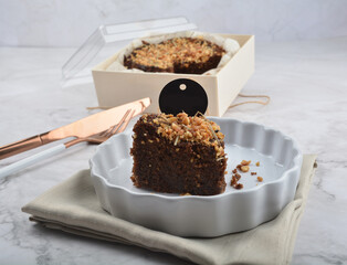 premium freshly baked dark cocoa chocolate brownie gold flower and earl grey peanut round birthday cake with walnut in wood bento box on white marble halal food sweet dessert menu for pastry cafe shop