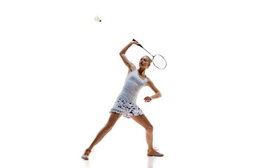 Concentrate young woman, badminton athlete in motion playing isolated over white background. Winning game. Concept of professional sport, active lifestyle, hobby, game