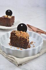 premium freshly baked dark cocoa chocolate brownie gold flower and earl grey peanut round birthday cake with walnut in wood bento box on white marble halal food sweet dessert menu for pastry cafe shop